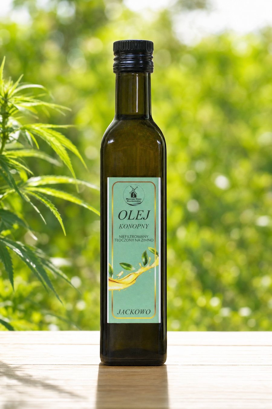 Butelka oleju konopnego na tle liści konopi